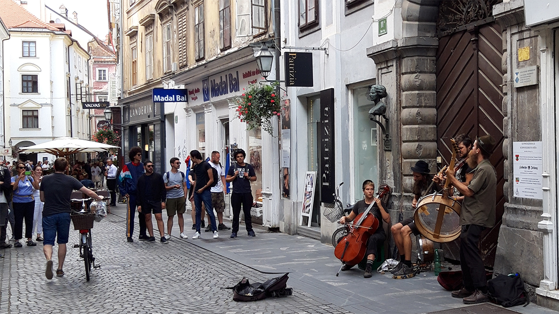 Buntes Treiben vor dem Schweigerhaus (slowenisch Schweigerjeva hiša) in Laibach/Ljubljana. Es beherbergt u. a. den Kulturverein deutschsprachiger Jugend in Slowenien und die »Laibacher Zeitung«