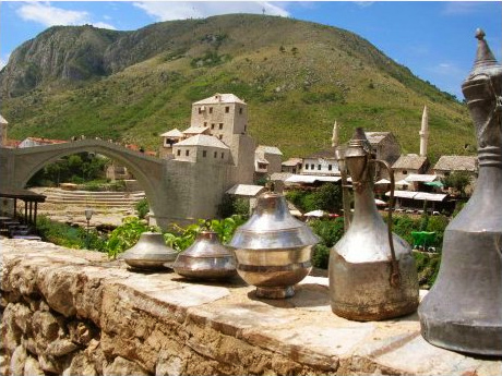 Handwerkserzeugnisse in der Altstadt von Mostar vor dem Hintergrund der alten Steinbrücke in Mostar.